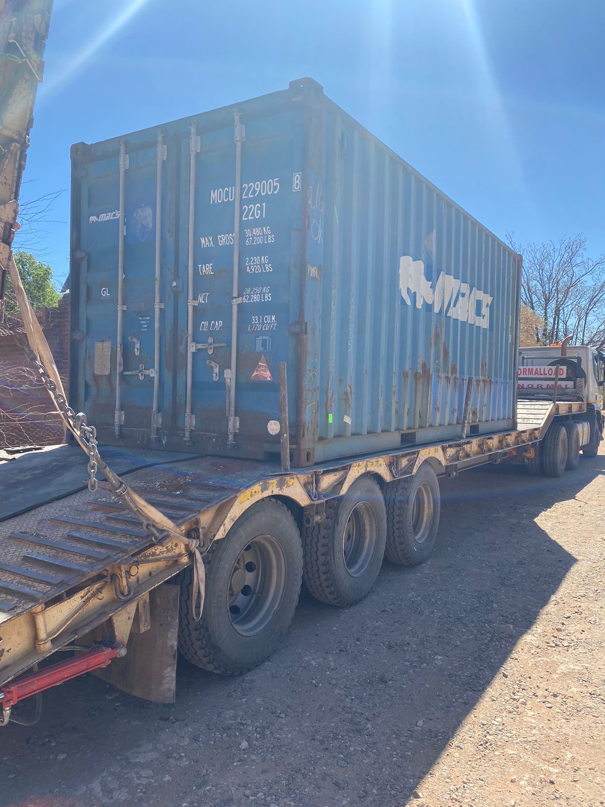Heavy logistics vehicle carrying a large modular container office conversion